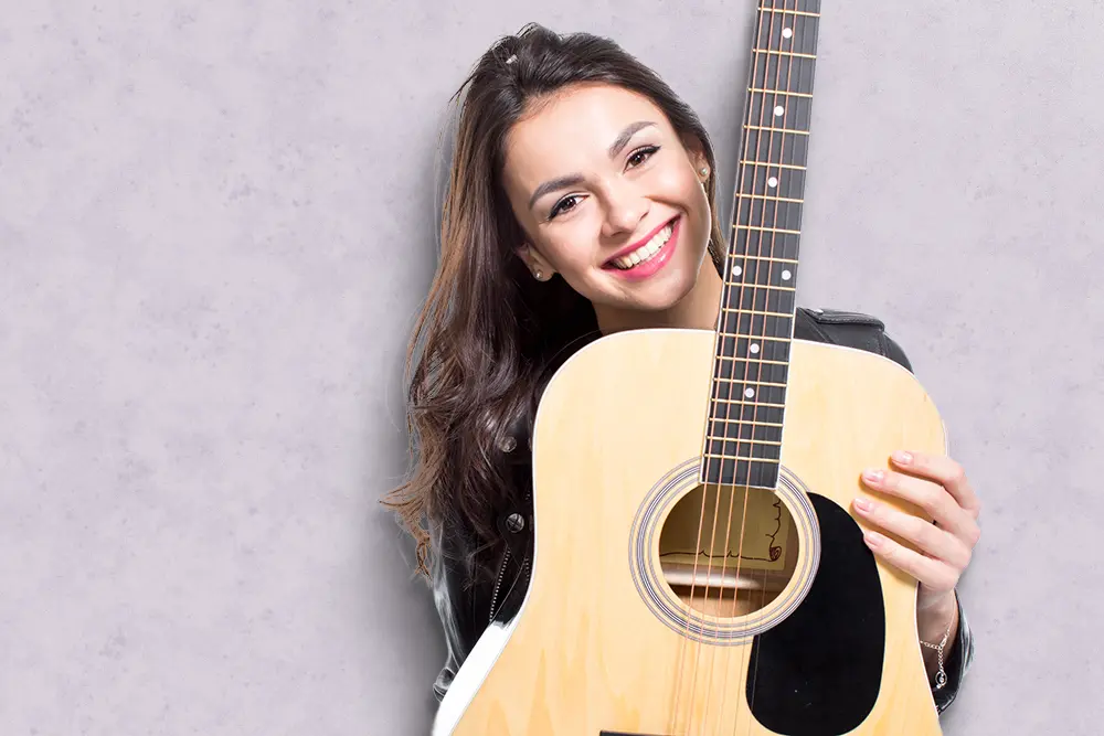 Young woman holding a guitar