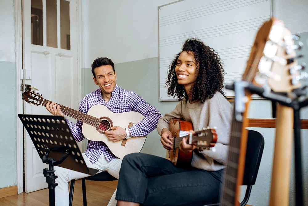 Friends learning Guitar at Tipsy Tunes